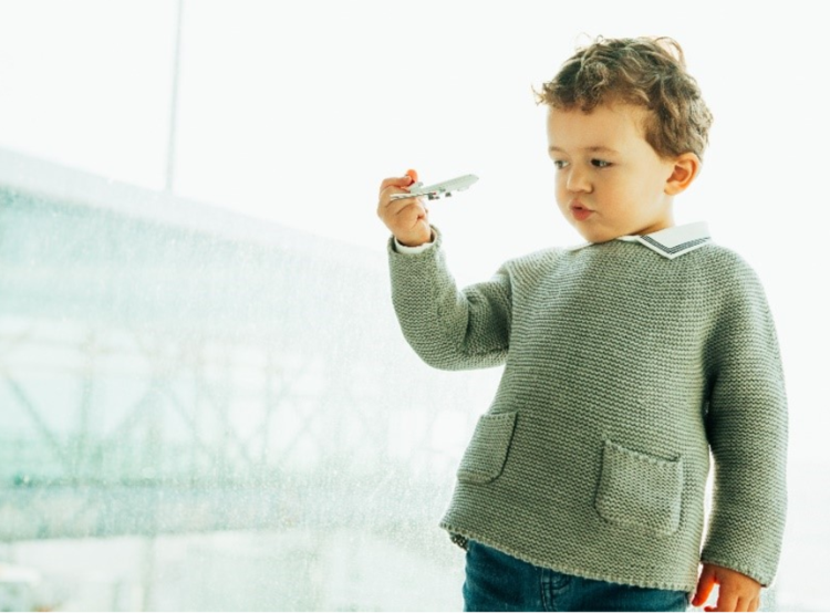 Boy holding airplane